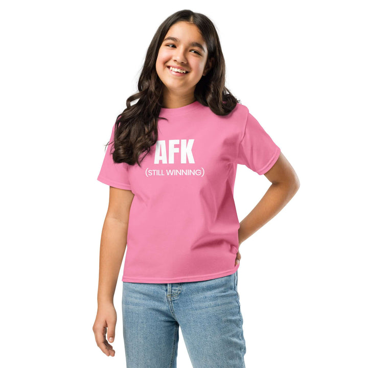 Youth wearing AFK Youth classic tee in pink color with a cheerful smile.