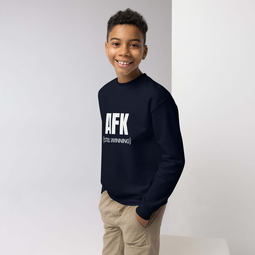 AFK Youth crewneck sweatshirt worn by a smiling boy, showcasing the stylish design in navy blue with a relaxed fit.