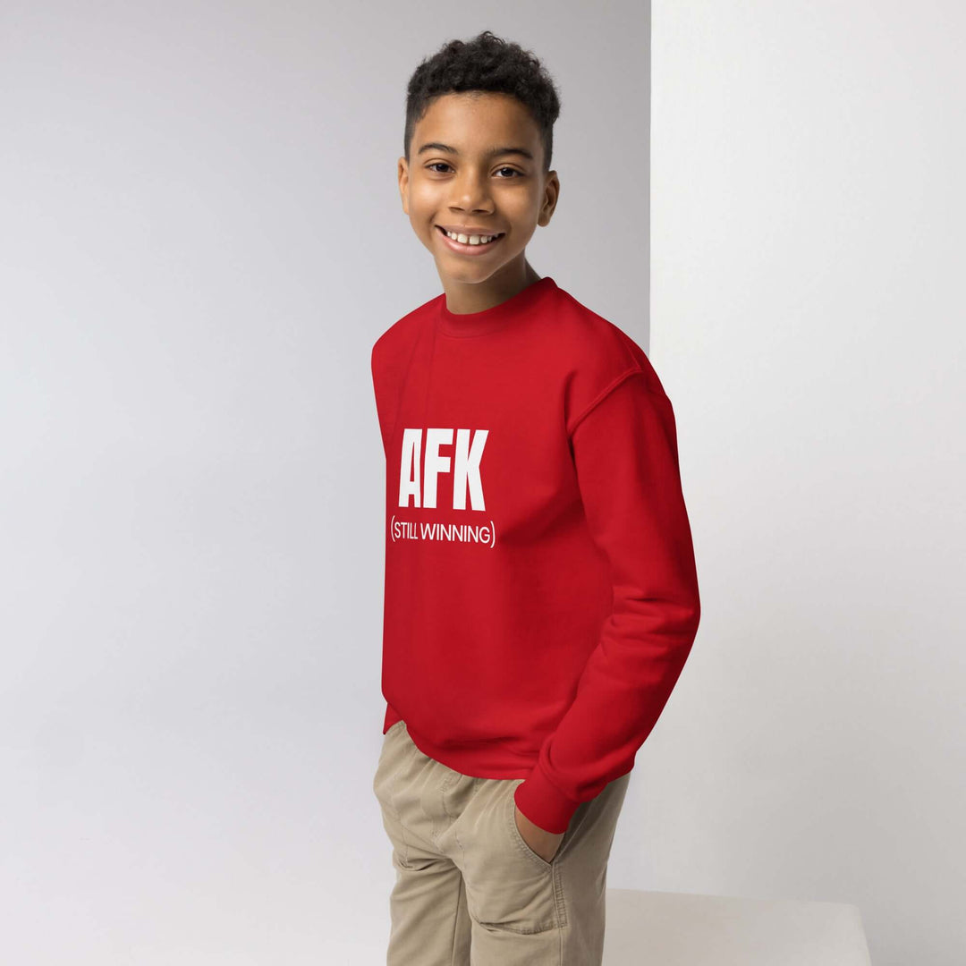 AFK Youth crewneck sweatshirt in red worn by a smiling boy, stylish and comfortable for any adventure.