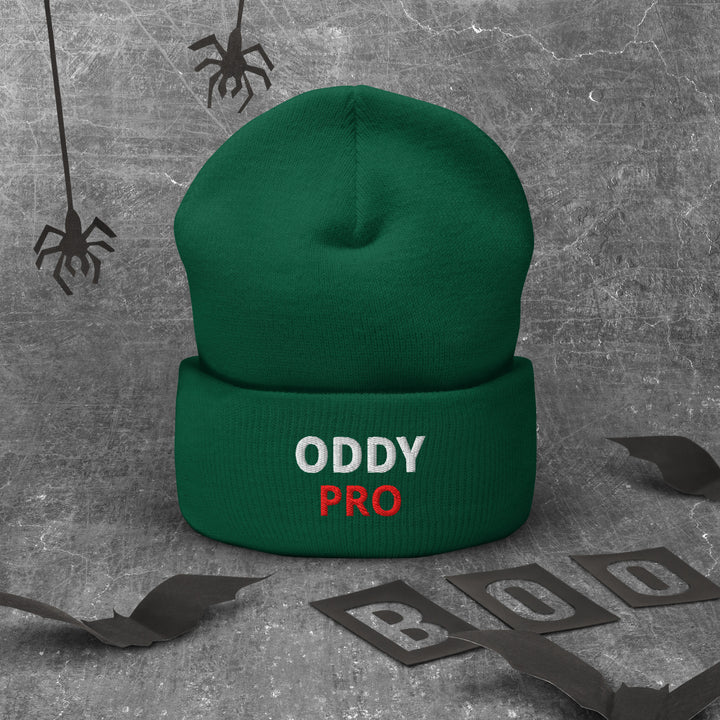 Oddy Pro Cuffed Beanie displayed on a textured background, featuring a snug green design with embroidered text.