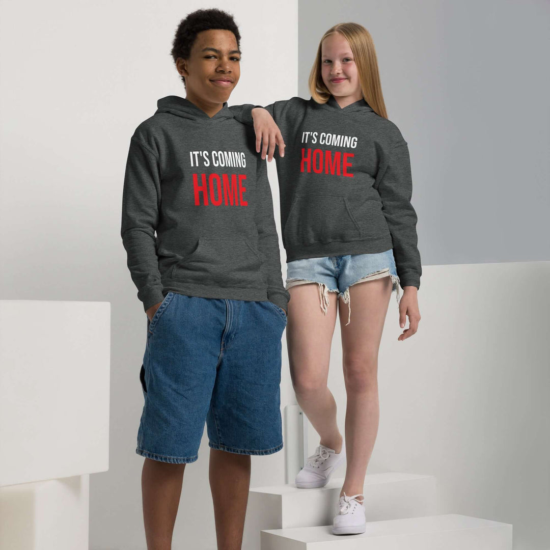 Youth heavy blend hoodie in grey worn by two kids, promoting comfort and style with text 'IT'S COMING HOME'.