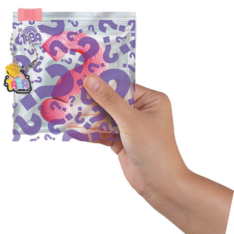 Hand holding Taba World Ready-Made Mystery Taba packaging with question marks and collectible tag.