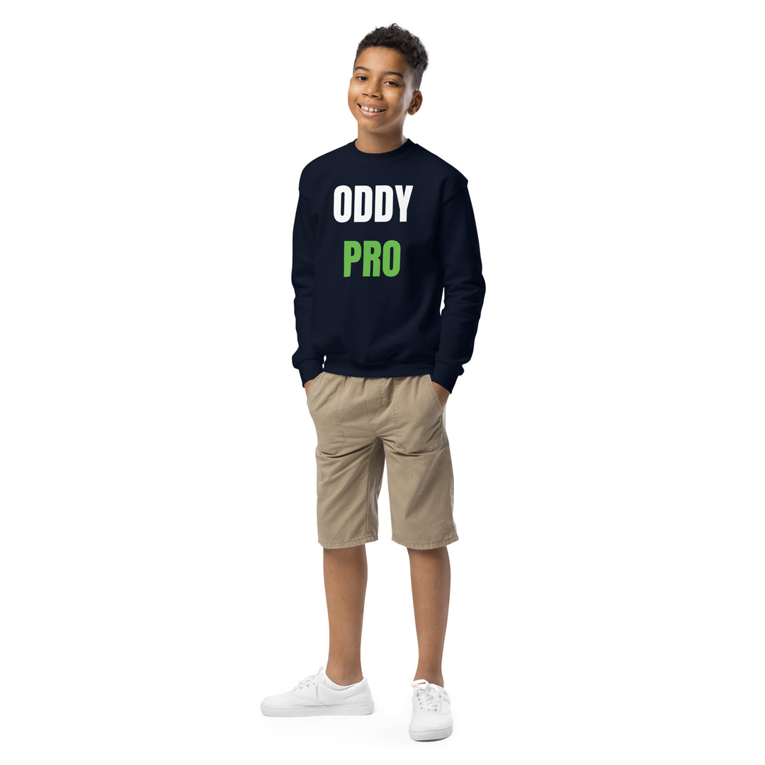 Youth wearing Oddy Pro Youth crewneck sweatshirt in navy, styled with khaki shorts, smiling.