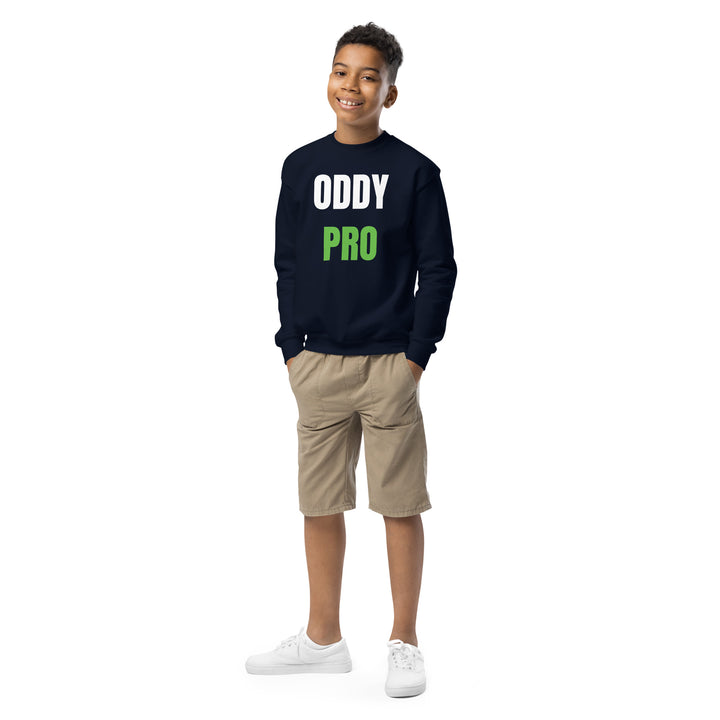 Youth wearing Oddy Pro Youth crewneck sweatshirt in navy, styled with khaki shorts, smiling.